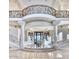 Impressive foyer showcasing a grand staircase, columns, and an ornate balcony at 7630 E Vaquero Dr, Scottsdale, AZ 85258