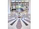Stunning foyer featuring marble floors, lion statue table and piano in the background at 7630 E Vaquero Dr, Scottsdale, AZ 85258