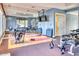 Well-equipped home gym featuring exercise machines, free weights, and a mirrored wall at 7630 E Vaquero Dr, Scottsdale, AZ 85258