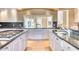 Spacious kitchen with dual islands, granite countertops, stainless steel appliances, and hardwood floors at 7630 E Vaquero Dr, Scottsdale, AZ 85258