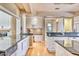 Bright kitchen with white cabinets, granite countertops, hardwood floors, and recessed lighting at 7630 E Vaquero Dr, Scottsdale, AZ 85258