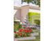 Lush backyard landscaping showcasing a fountain and vibrant red and white flowerbeds at 7630 E Vaquero Dr, Scottsdale, AZ 85258