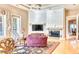 Inviting living room with a fireplace, TV, elegant decor, and plush seating, creating a warm and stylish space at 7630 E Vaquero Dr, Scottsdale, AZ 85258