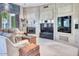 Spacious living room featuring decorative wall paneling, fireplace, flat screen television, and comfortable seating at 7630 E Vaquero Dr, Scottsdale, AZ 85258