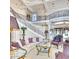 Luxurious living room with a curved staircase, custom railings, and stylish furnishings at 7630 E Vaquero Dr, Scottsdale, AZ 85258