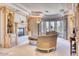 A stylish living room featuring a fireplace, custom millwork, large windows, and elegant seating at 7630 E Vaquero Dr, Scottsdale, AZ 85258