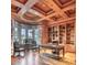 Elegant office with coffered wood ceiling, hardwood floors, and built-in bookshelves at 7630 E Vaquero Dr, Scottsdale, AZ 85258