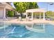 Backyard pool with outdoor seating area, landscaping, and partial view of the home's exterior at 7630 E Vaquero Dr, Scottsdale, AZ 85258