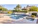 Backyard pool and spa with tiered landscaping, along with palm trees, tennis court, and other greenery at 7630 E Vaquero Dr, Scottsdale, AZ 85258