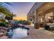 Stunning backyard showcasing a rock-accented pool, covered patio, and outdoor lounge area with a fireplace at 8427 E Preserve Way, Scottsdale, AZ 85266