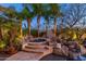 Relaxing backyard features a raised spa, lush landscaping, and stone accents for a tranquil retreat at 8427 E Preserve Way, Scottsdale, AZ 85266