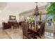 An open-concept dining area featuring a dark wood table, cushioned chairs, and decorative chandelier lighting at 8427 E Preserve Way, Scottsdale, AZ 85266