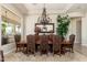 Formal dining room featuring a large wooden table, upholstered chairs, decorative chandelier, and a large mirror at 8427 E Preserve Way, Scottsdale, AZ 85266
