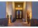 Inviting entryway featuring a wrought-iron door, flagstone flooring, and decorative potted plants for an elegant welcome at 8427 E Preserve Way, Scottsdale, AZ 85266