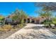 Single story home with a circular driveway, desert landscaping, and a covered entryway, all set under a clear sky at 8427 E Preserve Way, Scottsdale, AZ 85266