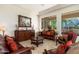 Comfortable living room with tile floors, large windows with desert views, and traditional furnishings with accent pillows at 8427 E Preserve Way, Scottsdale, AZ 85266