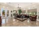 Spacious living room featuring dark sofas, upholstered chairs, area rug, with an abundance of natural light at 8427 E Preserve Way, Scottsdale, AZ 85266