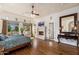 Spacious main bedroom with hardwood floors, tray ceiling, and a cozy fireplace at 8427 E Preserve Way, Scottsdale, AZ 85266