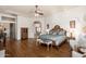 Spacious main bedroom with hardwood floors, tray ceiling, and decorative furnishings at 8427 E Preserve Way, Scottsdale, AZ 85266