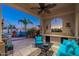 Outdoor patio with built in grill, bar seating, and lounge area with a charming fireplace at 8427 E Preserve Way, Scottsdale, AZ 85266
