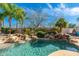 Sparkling pool features rock waterfalls, lush landscaping, and refreshing clear blue water at 8427 E Preserve Way, Scottsdale, AZ 85266