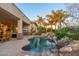 Inviting pool and patio area with mature palm trees create a resort-like backyard oasis at 8427 E Preserve Way, Scottsdale, AZ 85266