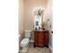 Powder room with a decorative mirror, chandelier, wood vanity, stone countertop and copper sink at 8427 E Preserve Way, Scottsdale, AZ 85266