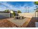 Cozy backyard with a stone patio, outdoor chairs and minimalist landscaping at 8750 E Starlight Way, Scottsdale, AZ 85250