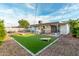 Backyard featuring artificial grass, corn hole, jacuzzi and covered patio at 8750 E Starlight Way, Scottsdale, AZ 85250