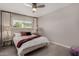 Bright bedroom featuring a ceiling fan, a large window, and neutral tones at 8750 E Starlight Way, Scottsdale, AZ 85250