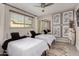 Shared bedroom featuring two twin beds, mirror closet doors and light grey interior at 8750 E Starlight Way, Scottsdale, AZ 85250