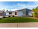 Charming single-story home featuring a well-manicured lawn and unique architectural details at 8750 E Starlight Way, Scottsdale, AZ 85250