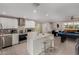 A modern open-concept kitchen features an island, white cabinets, and stainless steel appliances at 8750 E Starlight Way, Scottsdale, AZ 85250