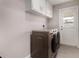 Laundry room with white cabinets and newer washer and dryer at 8750 E Starlight Way, Scottsdale, AZ 85250