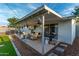 Relaxing covered patio with furniture, grill and a hot tub in the backyard at 8750 E Starlight Way, Scottsdale, AZ 85250