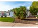 A side view of a single story home with gravel landscaping and mature vegetation at 8750 E Starlight Way, Scottsdale, AZ 85250