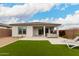 Spacious backyard with patio, artificial turf, built-in BBQ, and desert landscaping at 8751 S 168Th Dr, Goodyear, AZ 85338