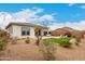 Well-maintained backyard with a covered patio, artificial turf, and desert landscaping at 8751 S 168Th Dr, Goodyear, AZ 85338