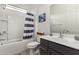 Well-lit bathroom with a shower-tub combo, single sink vanity, and modern fixtures at 8751 S 168Th Dr, Goodyear, AZ 85338