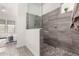 Bathroom with walk-in shower featuring stone tile at 8751 S 168Th Dr, Goodyear, AZ 85338