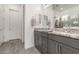 Bathroom vanity with granite countertops, dual sinks, and two mirrors at 8751 S 168Th Dr, Goodyear, AZ 85338