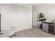 Bright bedroom features wood-look floors, a large closet, and a small beverage refrigerator at 8751 S 168Th Dr, Goodyear, AZ 85338