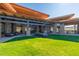 Modern clubhouse featuring stone accents, covered seating, and a well-maintained lawn at 8751 S 168Th Dr, Goodyear, AZ 85338
