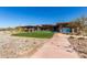 Community clubhouse with desert landscaping, walking paths, and scenic mountain views at 8751 S 168Th Dr, Goodyear, AZ 85338