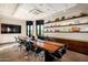 Modern conference room with a long table, black chairs, and decorative shelving at 8751 S 168Th Dr, Goodyear, AZ 85338