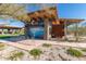 Exterior of a modern building with stone accents, a lakeside mural, and landscaping at 8751 S 168Th Dr, Goodyear, AZ 85338