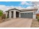 Charming single-story home featuring a brick driveway, stone accents and attached two-car garage at 8751 S 168Th Dr, Goodyear, AZ 85338