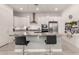 Bright kitchen features stainless steel appliances, marble countertops, island with seating, and wooden floors at 8751 S 168Th Dr, Goodyear, AZ 85338