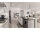 Bright kitchen features stainless steel appliances, marble countertops, island with seating, and wooden floors at 8751 S 168Th Dr, Goodyear, AZ 85338