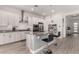 Bright kitchen features stainless steel appliances, marble countertops, island with seating, and wooden floors at 8751 S 168Th Dr, Goodyear, AZ 85338